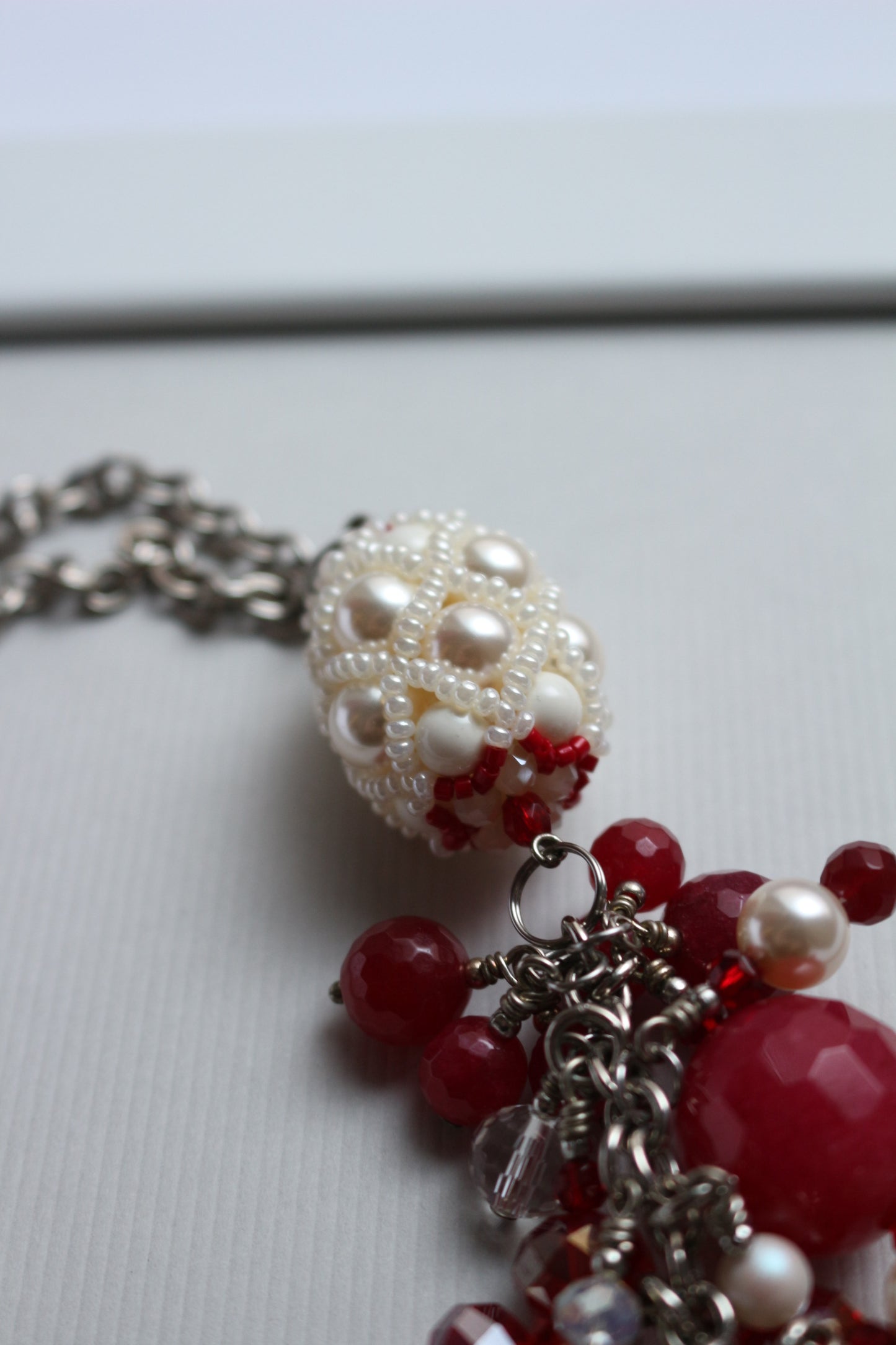 Necklace with red ruby and beaded element