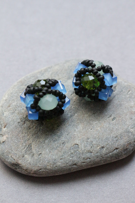 Pair of beaded element on a stone surface