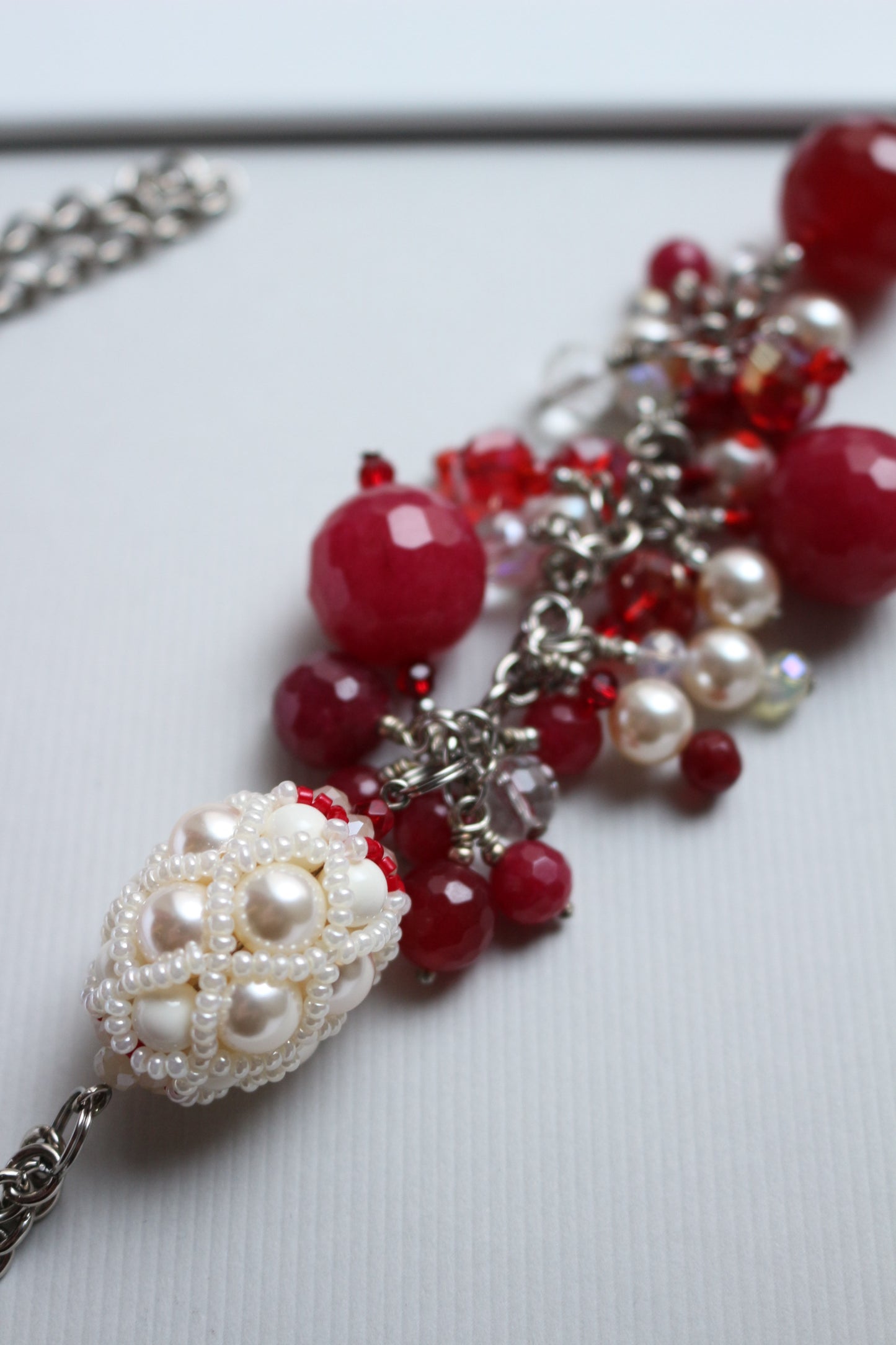 Necklace with red ruby and beaded element