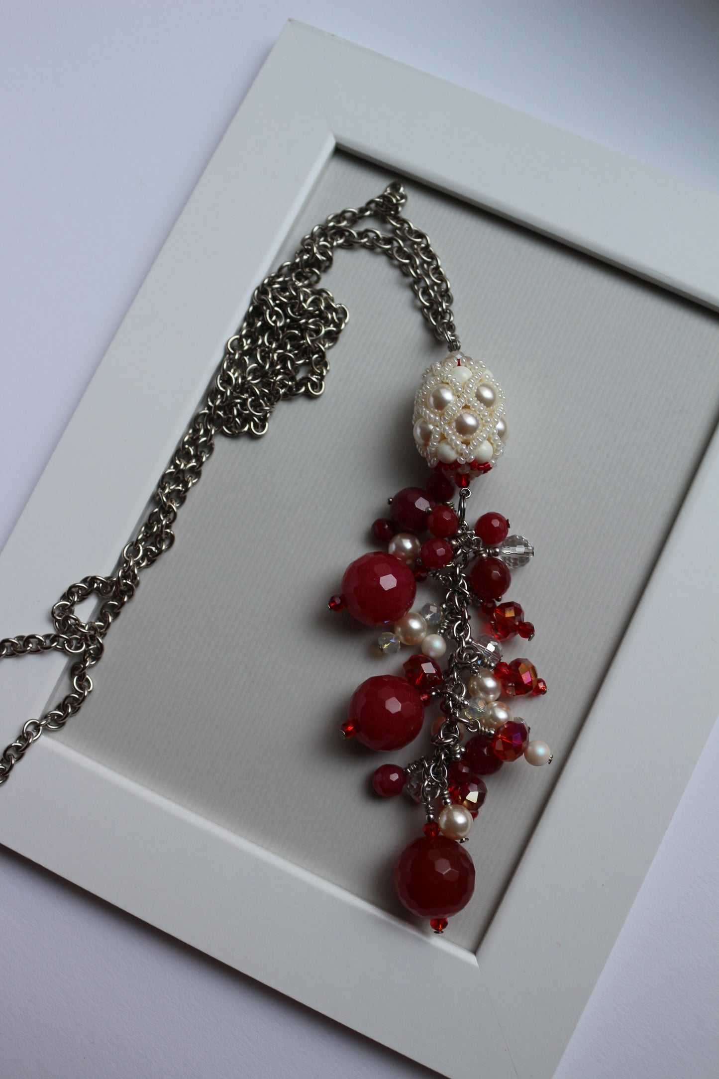 Necklace with red ruby and beaded element